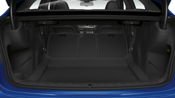 BMW 3 Series Sedan, trough-loading system Close-up of the opened trunk with the rear backseats half folded down.
