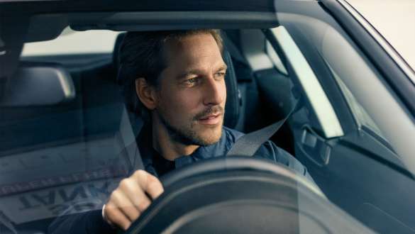 Man driving a BMW 5 Series Touring G31 Man driving BMW looking through windshield BMW 5 Series Touring G31 Facelift 2020