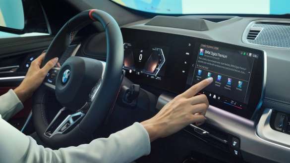 Woman in BMW operating display BMW interior Woman operating display