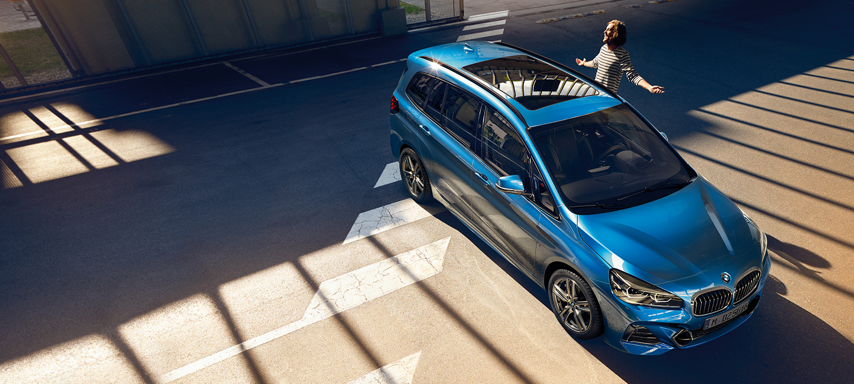 BMW 2 Series Gran Tourer with family Family standing next to BMW 2 Series Gran Tourer F46 Facelift 2018 Misano Blue metallic