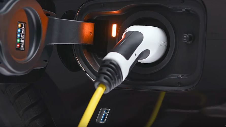 BMW plug-in hybrid connected with charging cable BMW 3 Series Sedan G20 BMW plug-in hybrid connected with charging cable close-up