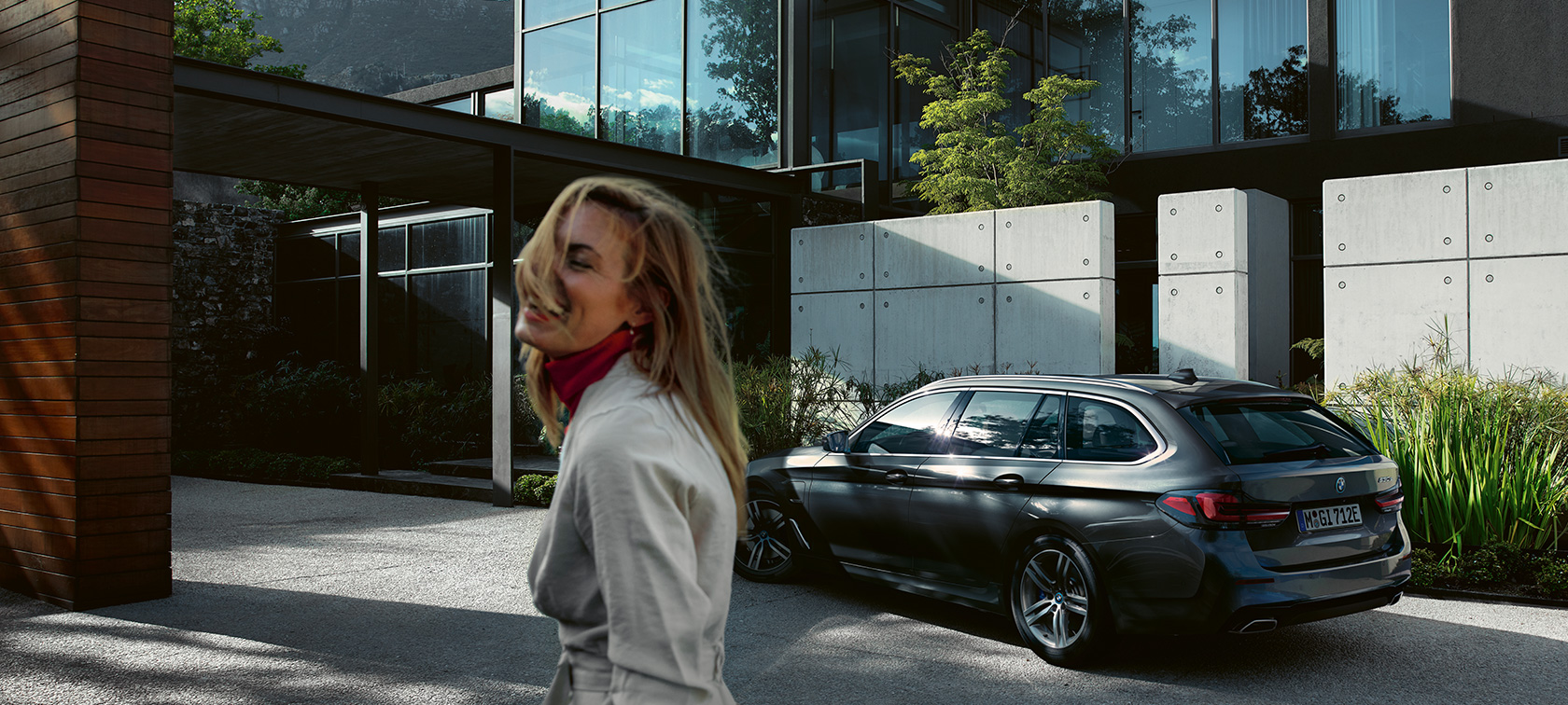 Woman in front of parking BMW 5 Series Touring BMW 5 Series Touring G31 Facelift 2020 woman in front of parking BMW