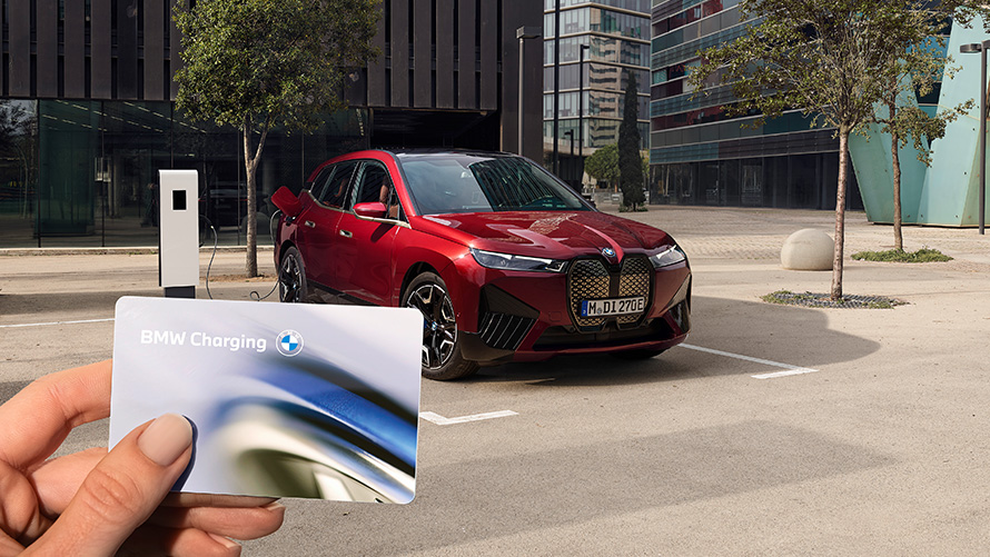 BMW iX i20 electric SUV BMW iX xDrive50 charging BMW iX i20 2021 electric SUV BMW iX xDrive50 Aventurin Red charging with a BMW Wallbox charging