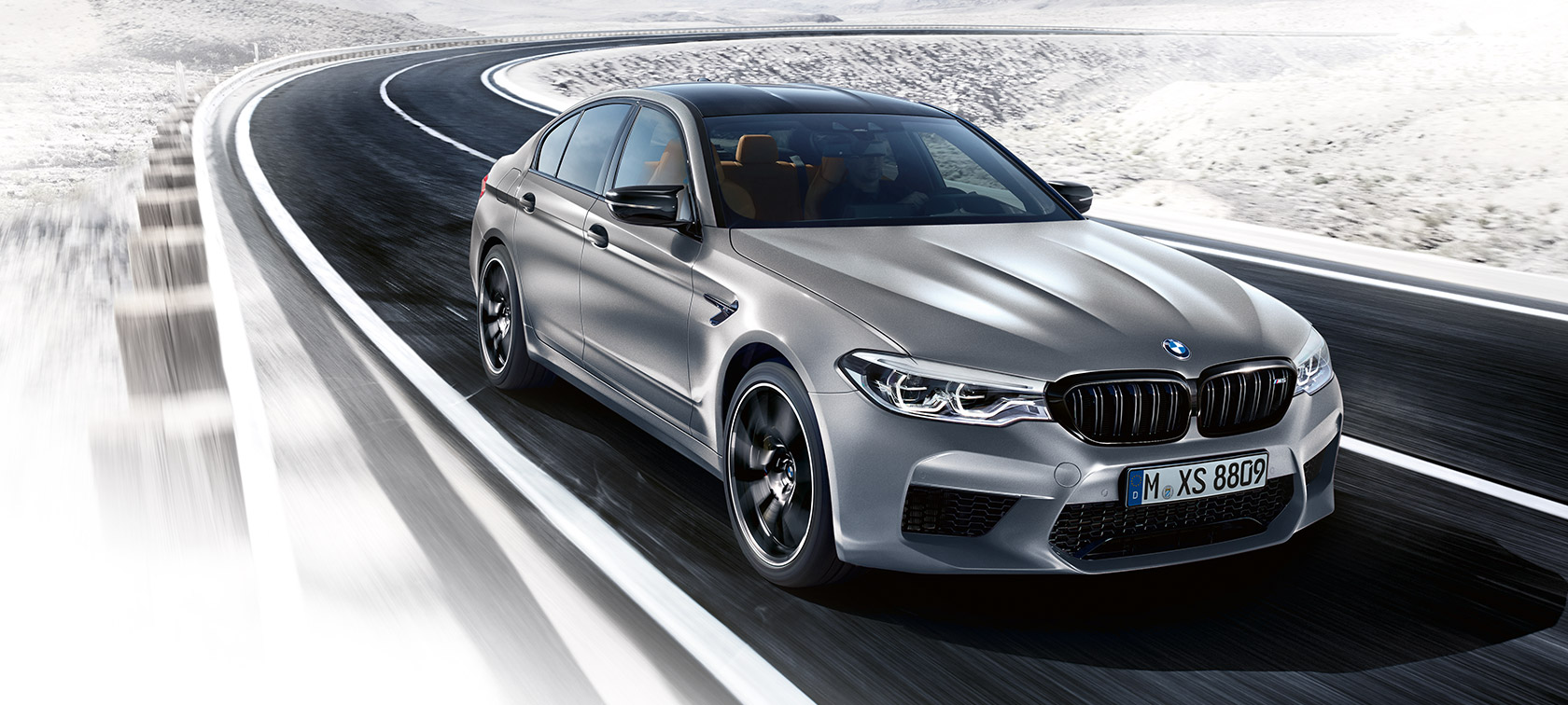 Design highlights. BMW M5 Competition driving shot three-quarter front.