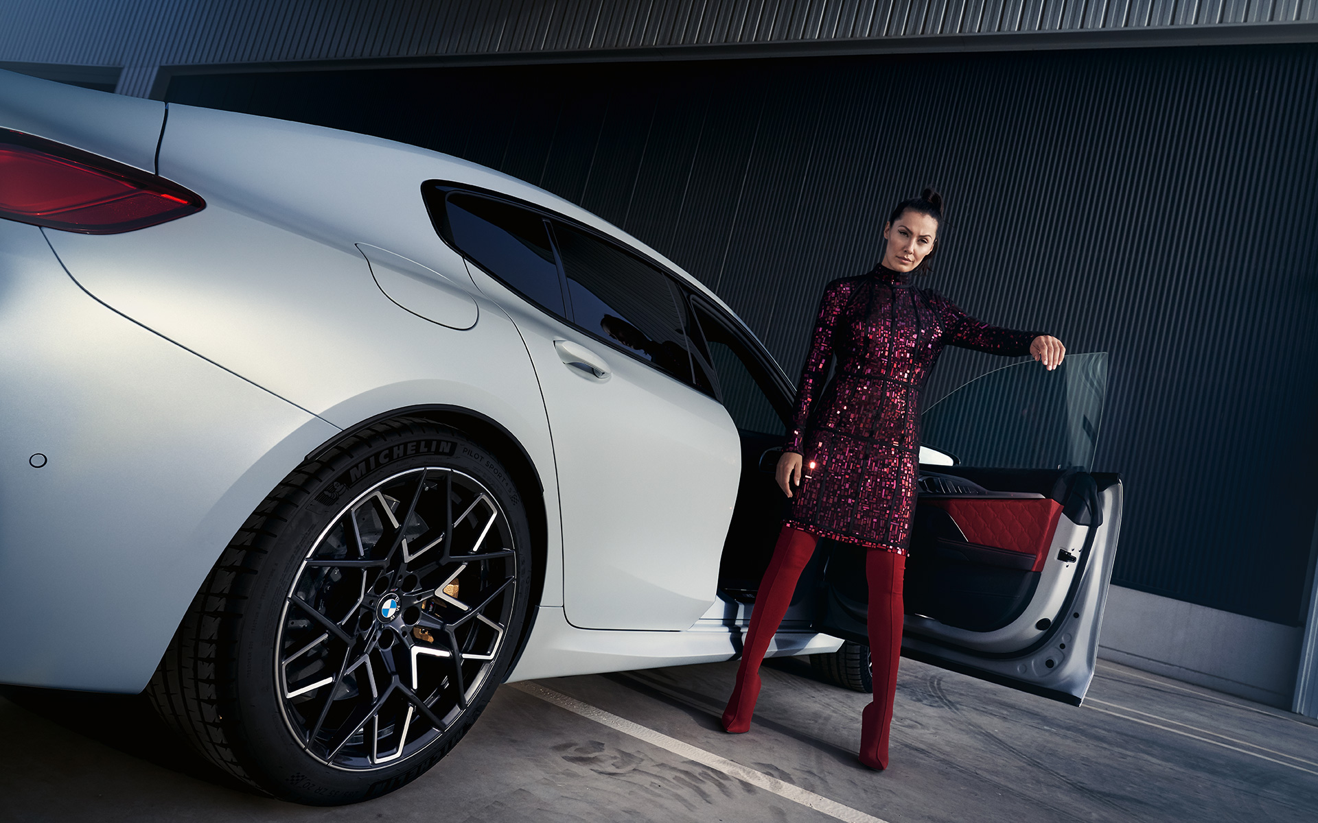 BMW M8 Competition Gran Coupé F93 LCI 2022 three-quarter rear view with model low angle shot BMW M8 Competition Gran Coupé F93 LCI Facelift 2022 BMW Individual Frozen Brilliant White metallic three-quarter rear view with model low angle shot