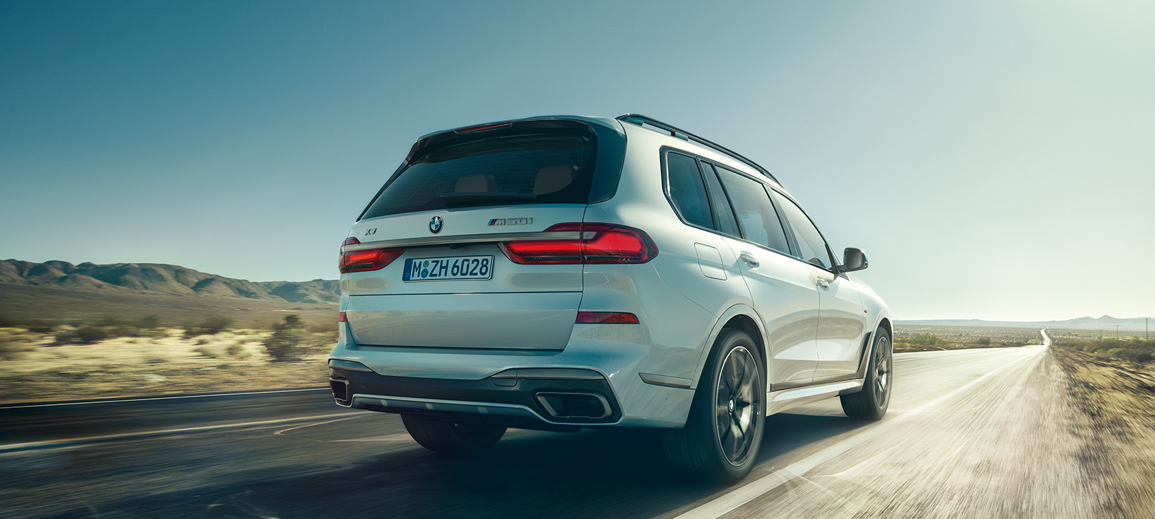 BMW X7 M50i, rear view BMW X7 M50i in Mineral White, driving on an empty highway, rear view, G07, 2019