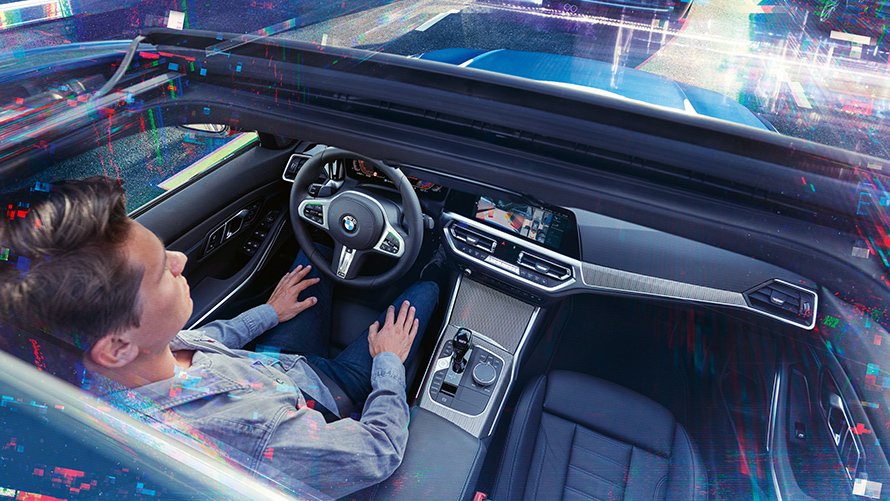 View in the cockpit of a BMW View in the cockpit of a BMW with man at the steering wheel