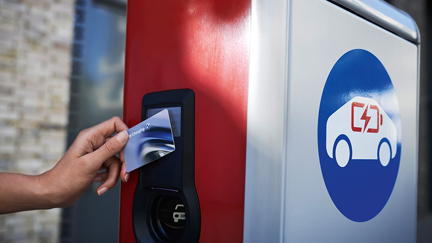 Public charging with BMW Charging Card Person holds BMW Charging Card at public charging station
