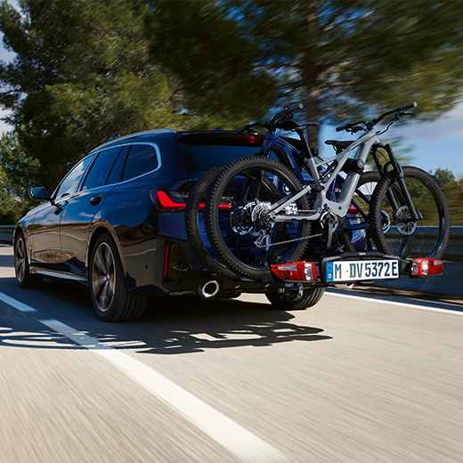 BMW 3er Touring G21 PHEV 3/4 rear view with bicycles driving