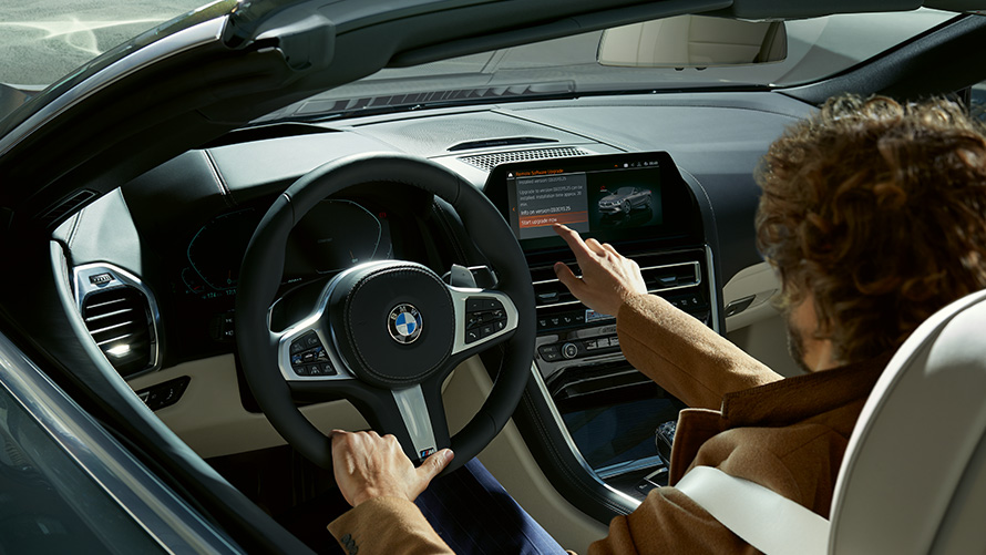 Remote Software Upgrade Remote Software Upgrade Man sitting in a BMW and using the Control Display