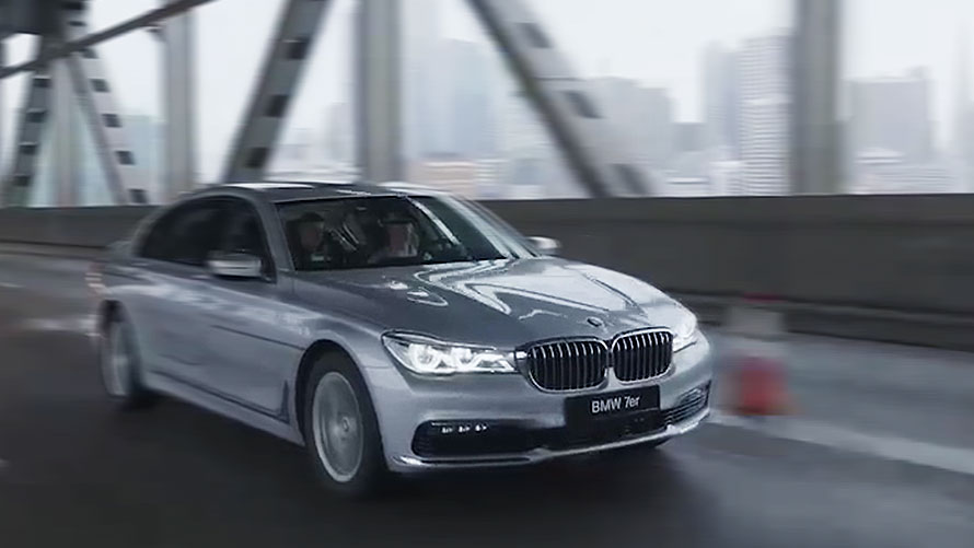 BMW Autonomous Driving – AI-Driven Control in Urban Environments BMW 7 Series driving autonomously on a city bridge, representing the brand's advancement in AI-powered autonomous mobility