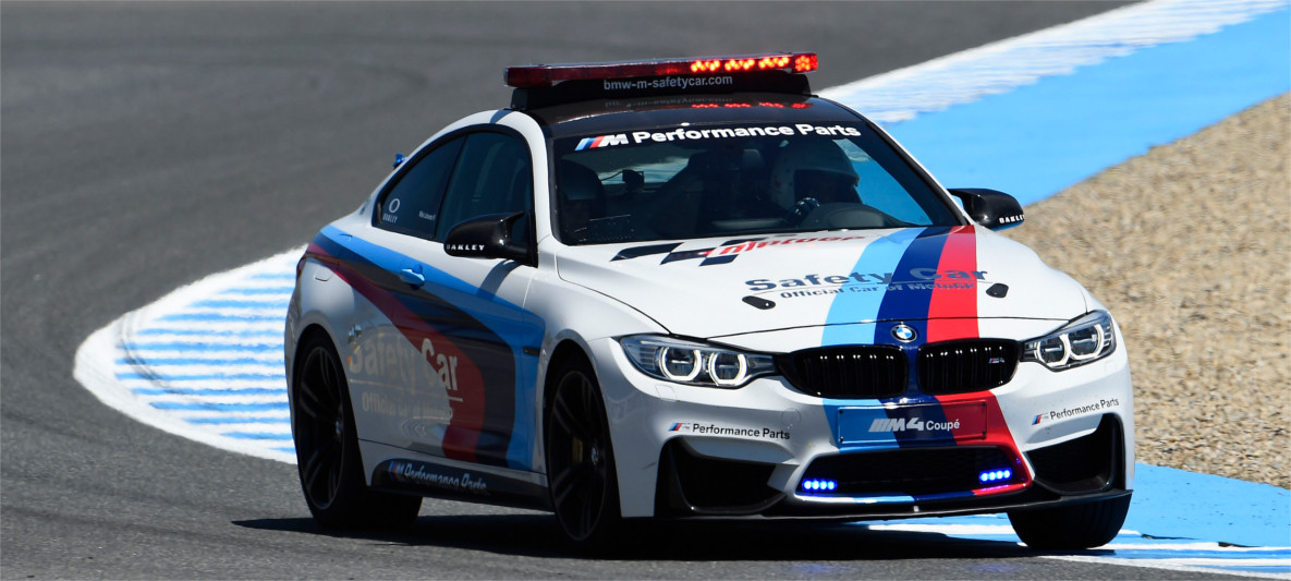 BMW M4 Coupé MotoGP Safety Car on racetrack, equipped with M Performance Parts and official livery for high-speed motorsport support