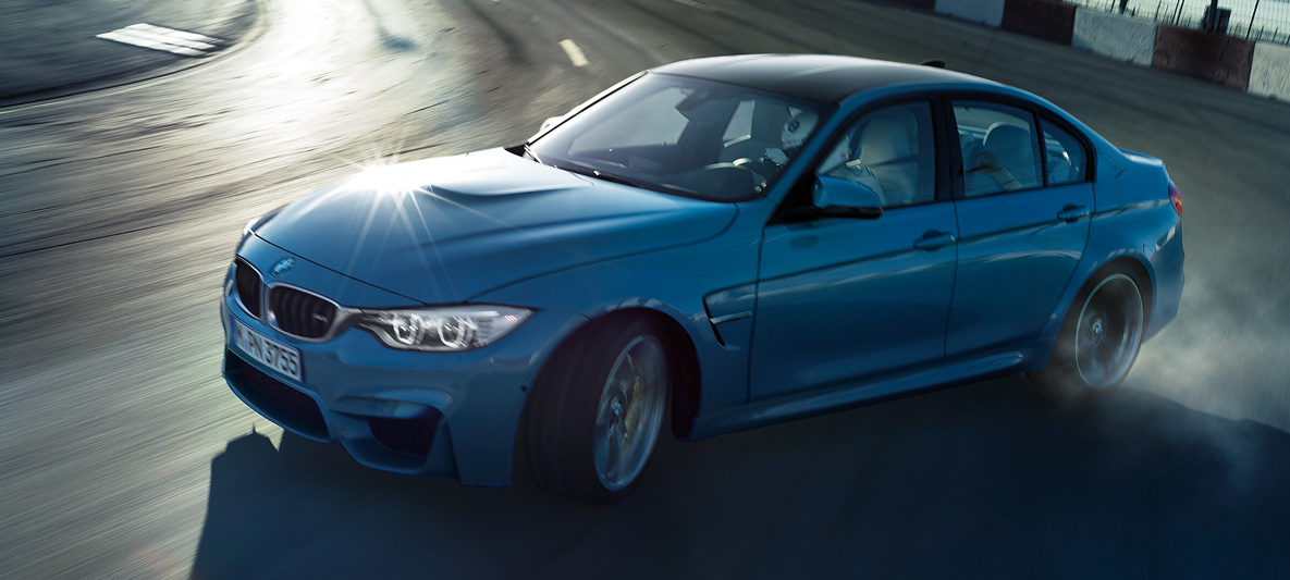 BMW M3 drifting on a race track at sunset with dynamic lighting, showcasing precision control, power, and M aerodynamic styling